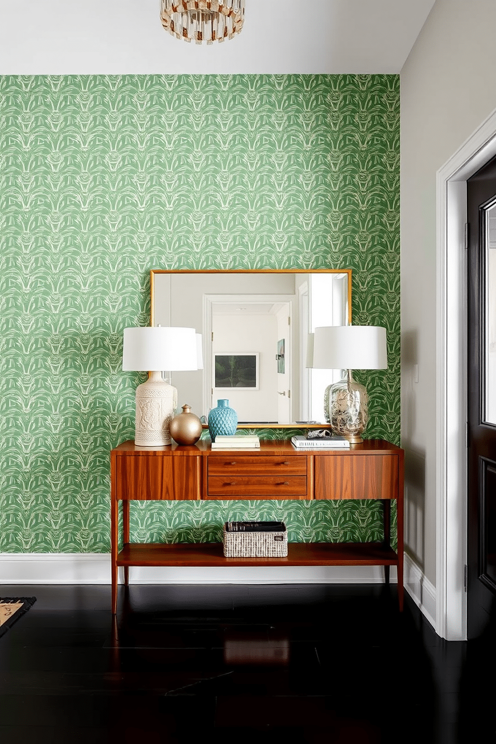 A striking foyer features a geometric green wallpaper accent wall that adds depth and visual interest. The space is complemented by a sleek console table in a rich wood finish, adorned with decorative objects and a large mirror that reflects light throughout the area.