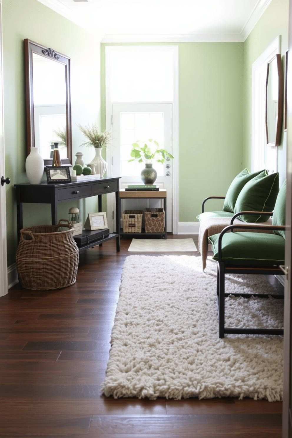 Layered textures create a cozy atmosphere in the foyer, featuring a plush area rug that complements the rich, dark hardwood flooring. A stylish console table adorned with decorative objects and a large mirror enhances the sense of space, while green cushions on a nearby bench add a pop of color and comfort. The foyer is painted in a soft, inviting shade of green, providing a fresh backdrop for the layered design elements. Natural light pours in through a large window, illuminating the space and highlighting the interplay of textures, from the woven basket to the velvet cushions.