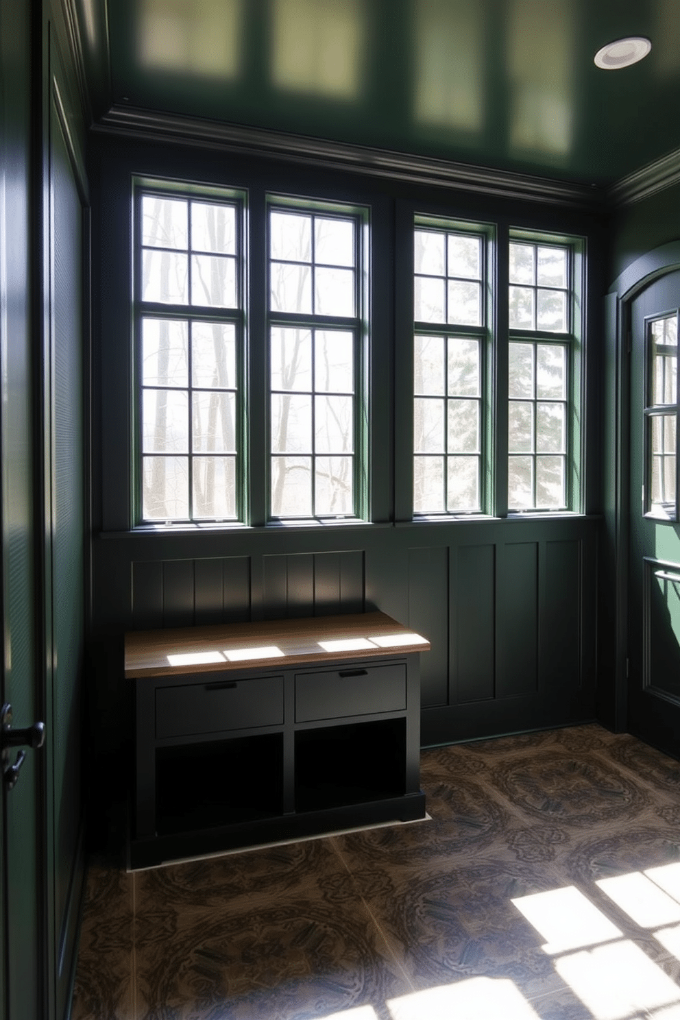 A deep green mudroom features large windows that allow natural light to flood the space, creating an inviting atmosphere. The walls are adorned with rich, textured paneling, and the floor is covered with durable, patterned tiles that add visual interest.