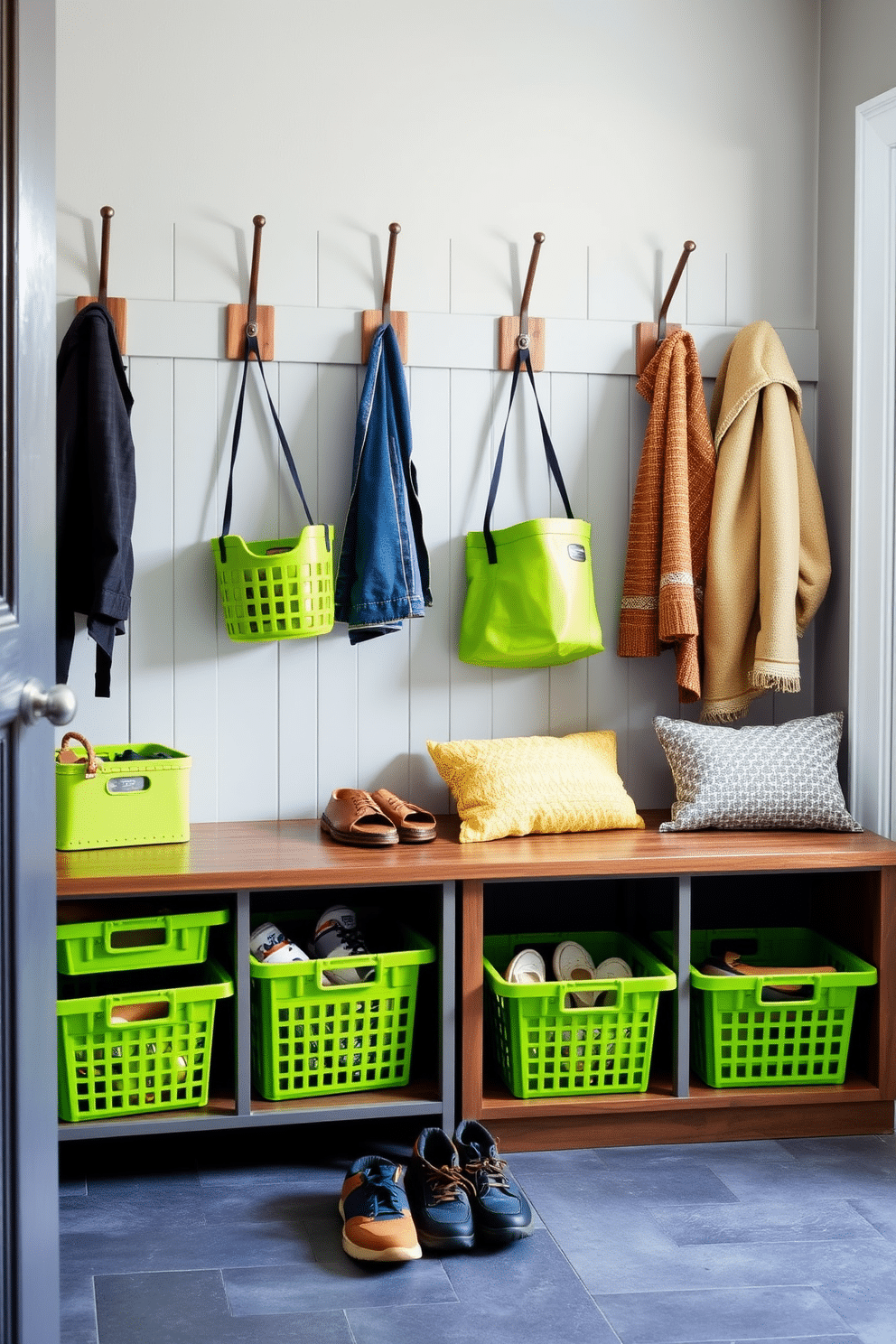 A vibrant mudroom featuring lime green baskets for shoes and gear, neatly organized along a stylish bench. The walls are painted a soft gray, complemented by rustic wooden hooks for coats, creating a functional yet inviting space.