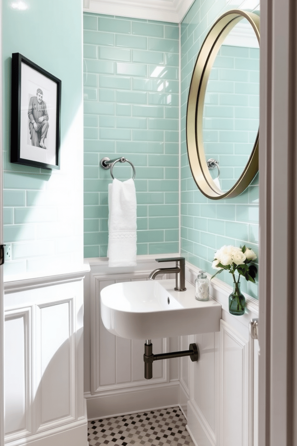 A stylish powder room featuring mint green tiles that create a refreshing and vibrant atmosphere. Modern fixtures, including a sleek wall-mounted sink and a contemporary faucet, complement the elegant tile work. The walls are adorned with subtle white wainscoting, adding a touch of classic charm to the space. A large round mirror with a minimalist frame reflects the natural light, enhancing the room's brightness and openness.