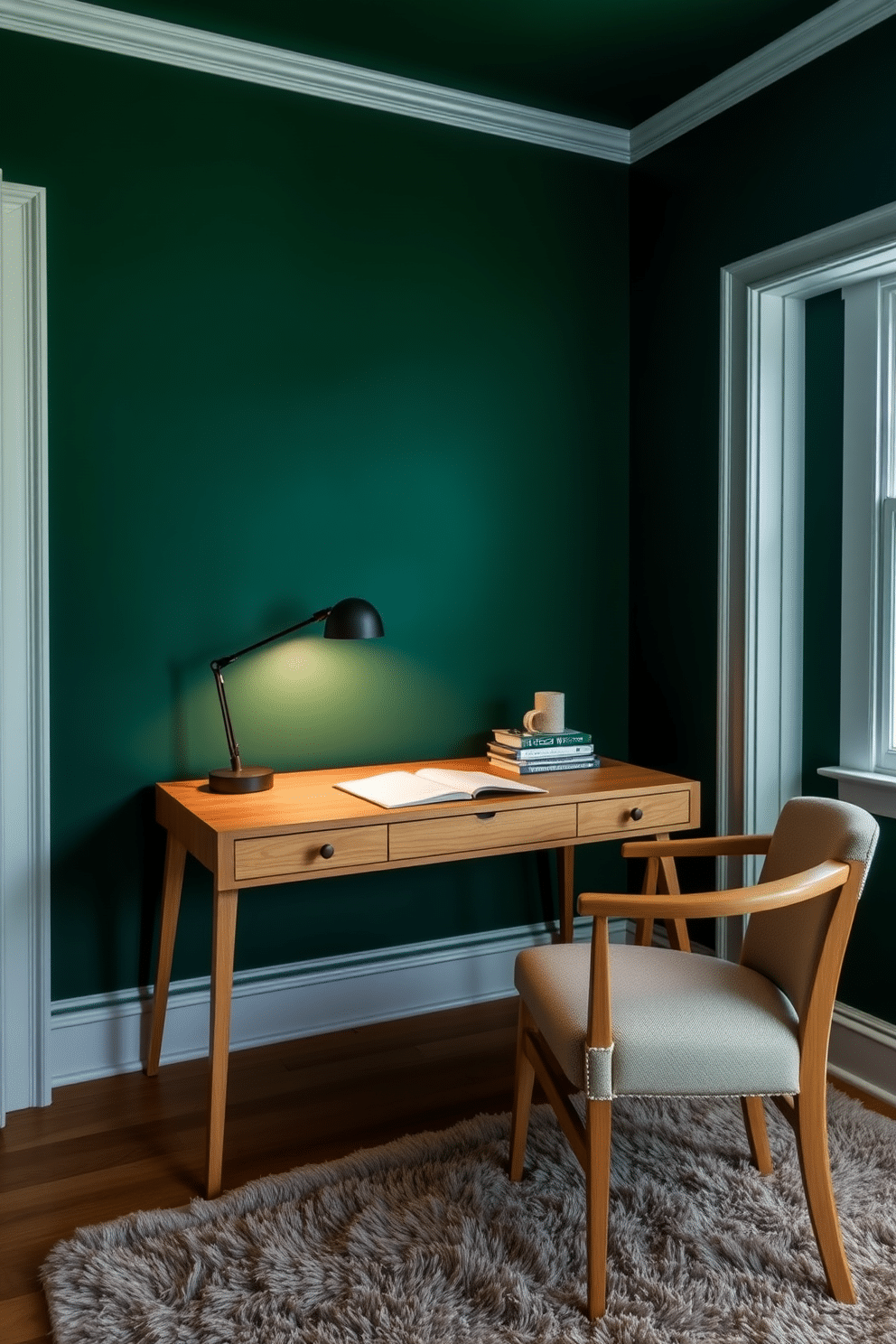 A natural wood desk sits against a rich green backdrop, creating a serene and inviting study space. The desk is adorned with a sleek lamp and a few carefully arranged books, enhancing the room's tranquil atmosphere. The walls are painted in a deep forest green, complemented by white trim that adds a touch of brightness. A plush, neutral-colored rug anchors the space, while a comfortable chair invites hours of focused work or study.