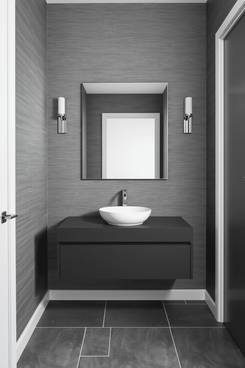 A sleek half bath featuring a monochromatic color scheme with varying shades of gray. The walls are adorned with a textured gray wallpaper, while the floor showcases large, polished gray tiles. A modern floating vanity in a deep charcoal finish holds a simple white vessel sink. Above the vanity, a frameless mirror enhances the minimalist aesthetic, reflecting the ambient lighting from stylish wall sconces.