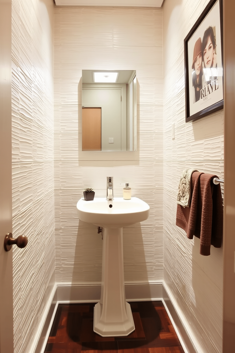 A stylish half bath featuring textured wall panels that create depth and visual interest. The space is adorned with a sleek pedestal sink and a modern faucet, complemented by a chic mirror that enhances the room's elegance. The flooring is a rich, dark wood that contrasts beautifully with the light-colored walls, while ambient lighting casts a warm glow throughout the area. Accessories like a small potted plant and decorative hand towels add a touch of personality to this inviting powder room.