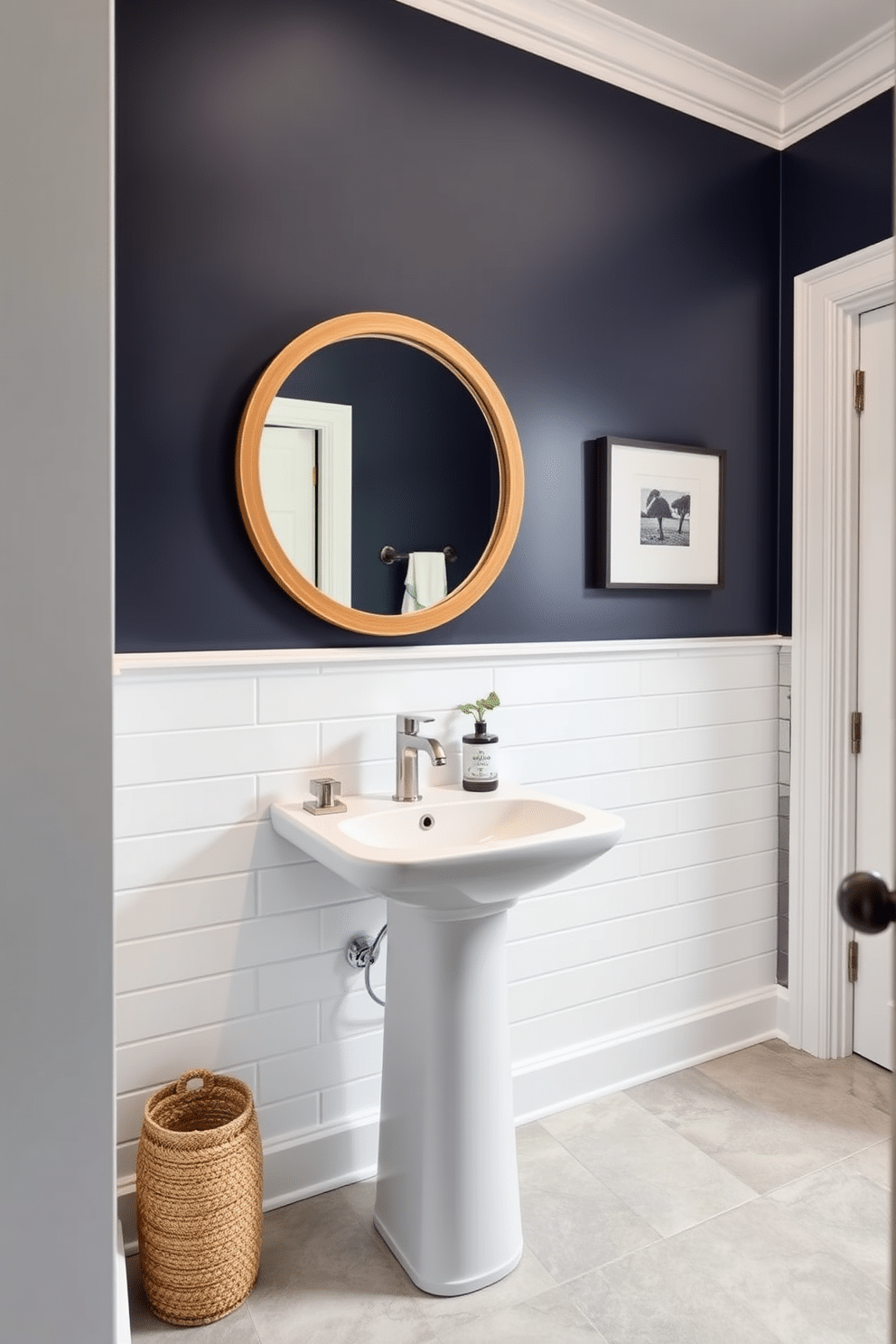 A stylish half bath featuring an accent wall painted in a bold navy blue, contrasting beautifully with the soft white of the remaining walls. The space includes a sleek pedestal sink with a brushed nickel faucet and a round mirror framed in natural wood, enhancing the modern aesthetic. The floor is adorned with large, light gray tiles, providing a clean and contemporary look. Decorative elements like a small potted plant and a chic soap dispenser add a touch of warmth and personality to the powder room.