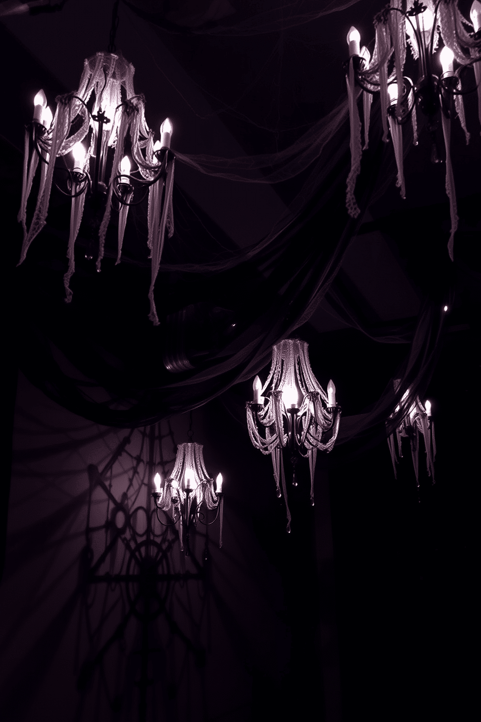 A dramatic basement setting adorned with chandeliers draped in black lace creates an eerie yet elegant atmosphere. The dim lighting casts intricate shadows on the walls, enhancing the spooky ambiance. Decorative cobwebs are artfully arranged across the ceiling, complementing the lace of the chandeliers. Dark, rich colors dominate the space, with deep purples and blacks adding to the Halloween theme.