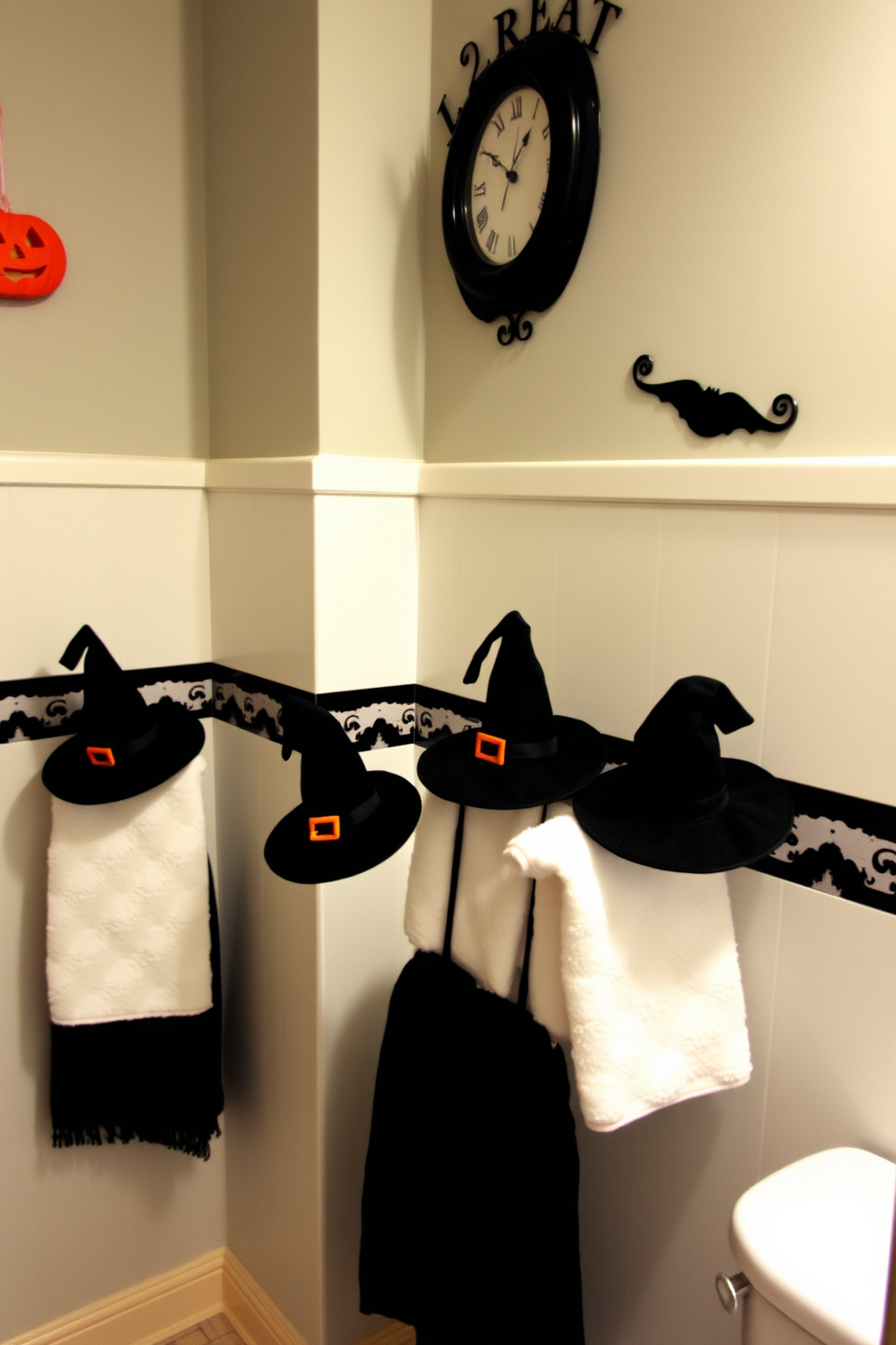 A whimsical bathroom decorated for Halloween. Mini witch hats are playfully hung on the towel racks, adding a festive touch to the space.