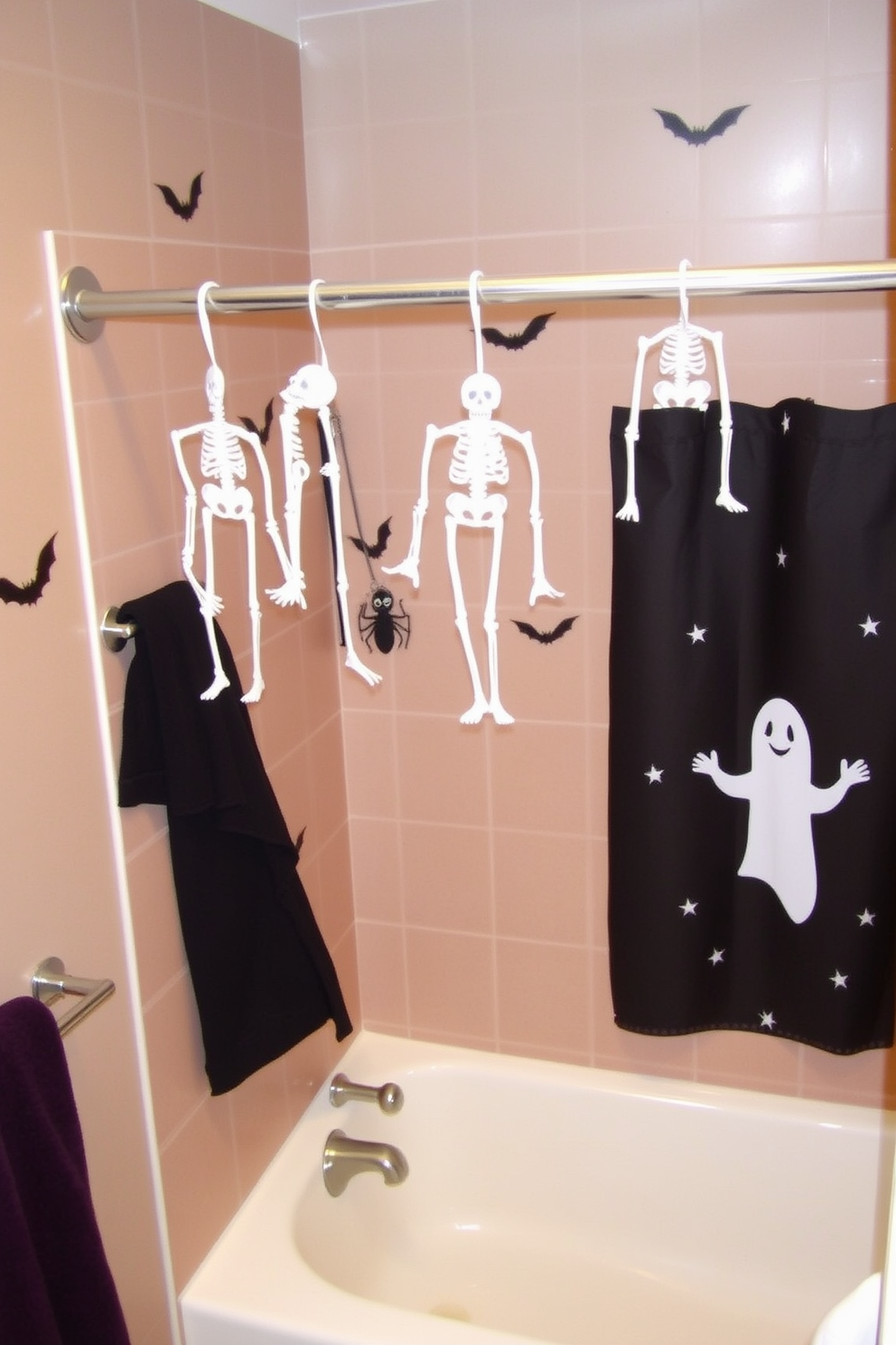 A whimsical Halloween bathroom setting featuring hanging skeletons from the shower rod. The walls are adorned with spooky decals and the shower curtain displays a ghostly design.