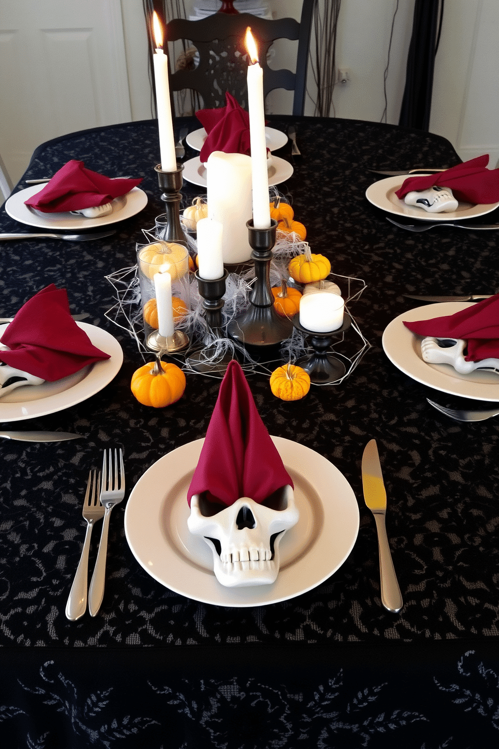 Create a spooky themed table setting for a Halloween dinner. The table is covered with a black lace tablecloth, and each place setting features a skull-shaped plate with a silver fork and knife on either side. Candles in varying heights flicker in the center, surrounded by miniature pumpkins and cobwebs. Dark red napkins are folded into ghost shapes and placed on each plate, adding an eerie touch to the overall ambiance.