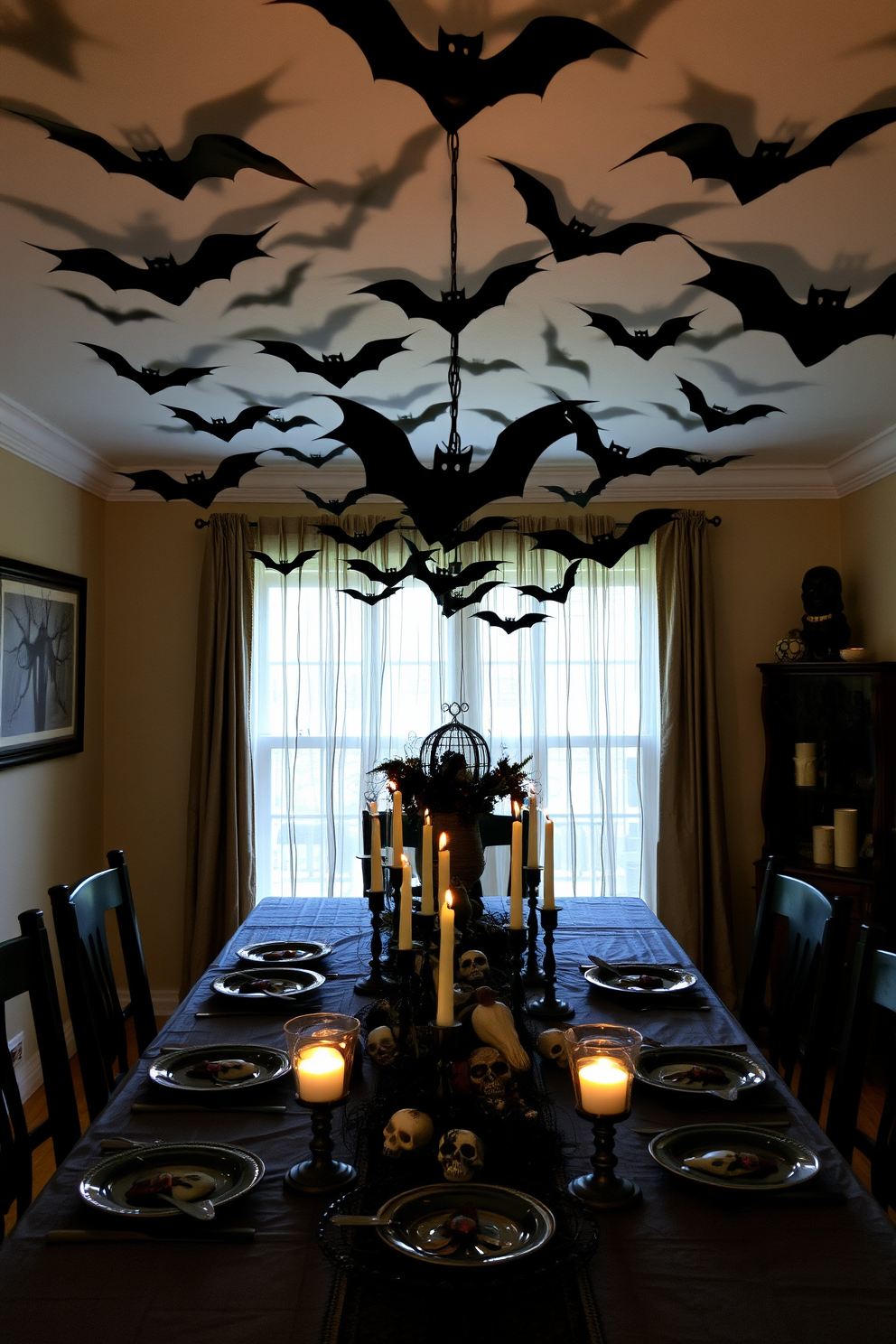 A spooky dining room setting for Halloween. The ceiling is adorned with eerie hanging bats made of black paper, casting shadows over the table. The table is set with a dark, rustic tablecloth and features an assortment of creepy, themed decorations. Flickering candlelight in skull-shaped holders adds an unsettling ambiance to the space.