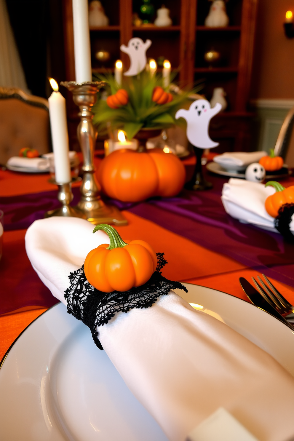 A festive Halloween-themed dining room setting features elegant napkin rings adorned with miniature pumpkins and black lace accents. The table is set with deep orange and purple tablecloths, complemented by flickering candlelight and whimsical ghost decorations.