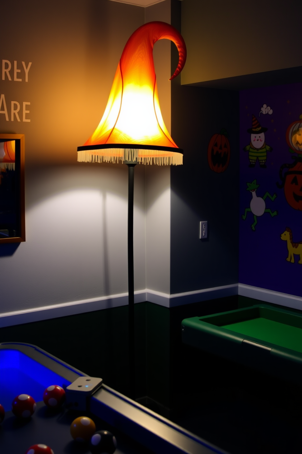 A whimsical witch hat lamp casts a soft glow in the corner of a vibrant game room. The walls are adorned with playful Halloween-themed artwork, creating a festive atmosphere perfect for entertaining friends.