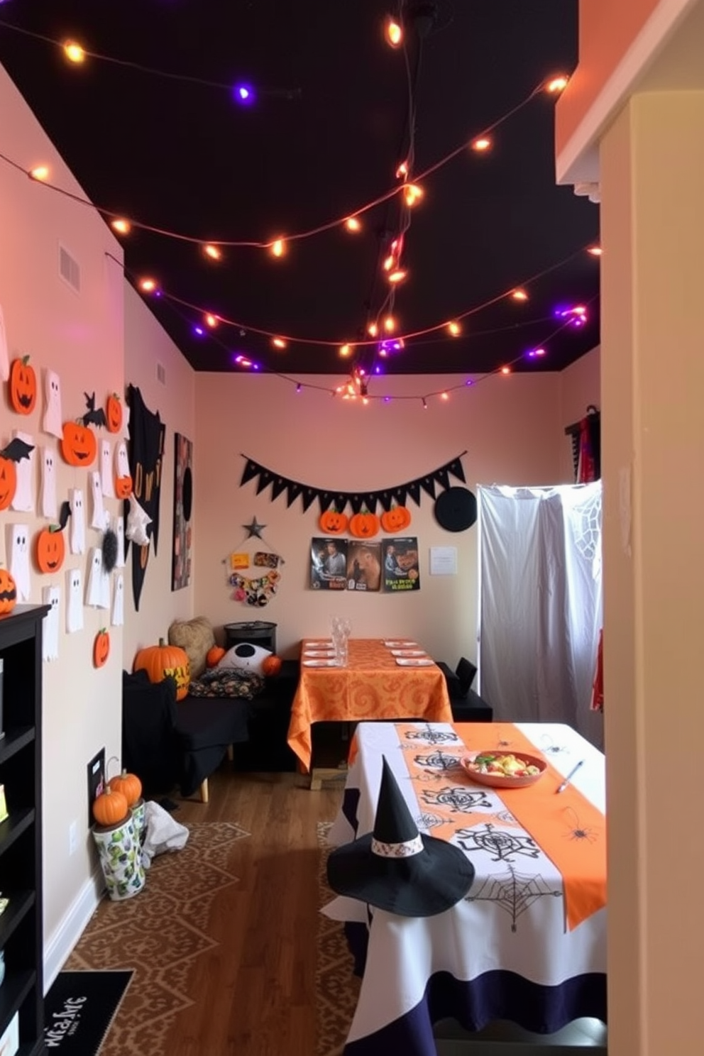 A cozy Halloween game room filled with festive decorations. The walls are adorned with handmade crafts featuring ghosts and pumpkins, while a large table is set up for games with spooky-themed tablecloths. A corner is dedicated to a DIY photo booth with props like witch hats and fake spider webs. String lights in orange and purple hang from the ceiling, creating an inviting atmosphere for friends and family.