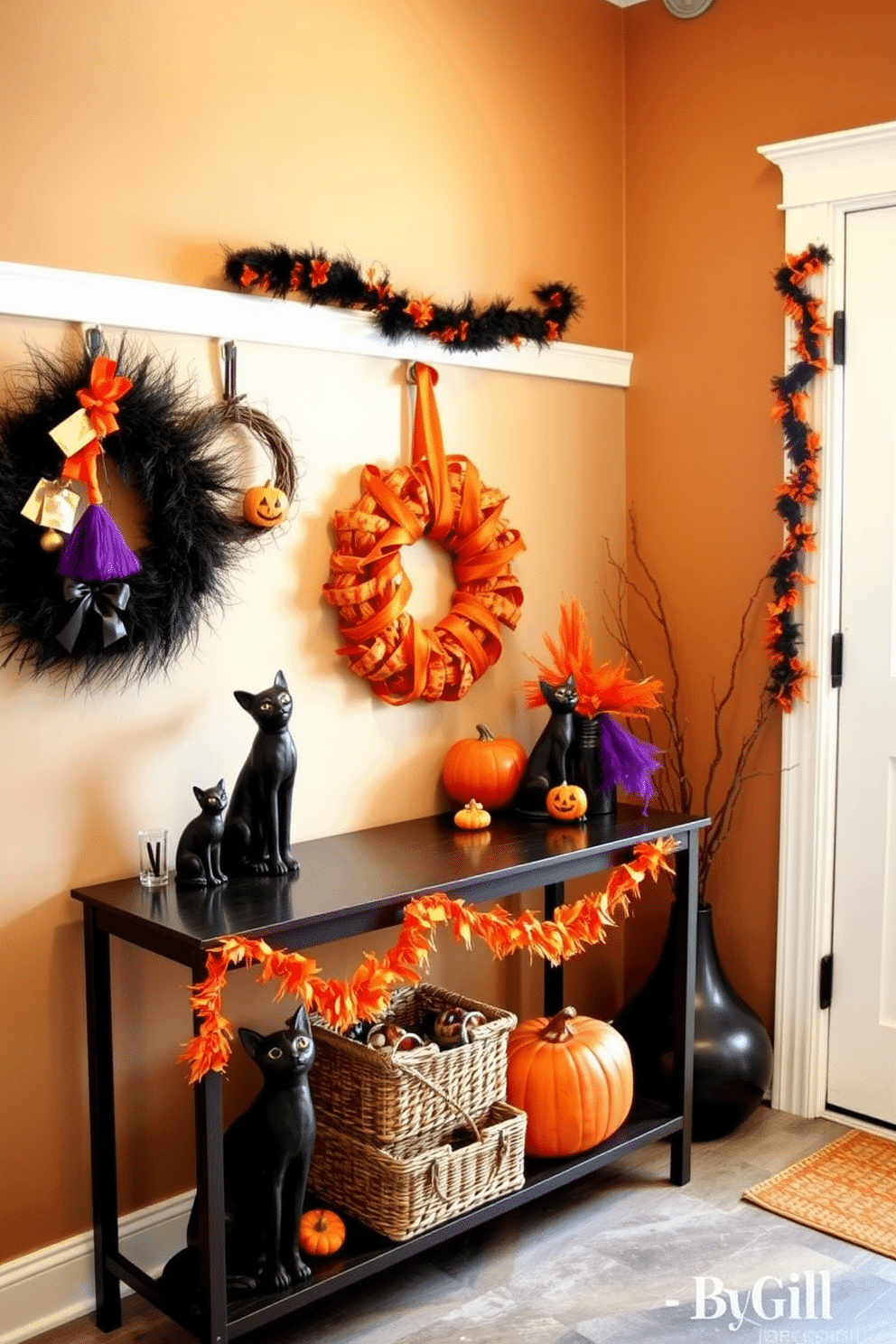 A stylish mudroom designed for Halloween. The space features a console table adorned with black cat figurines, surrounded by festive decorations in shades of orange and purple. The walls are painted a warm neutral tone, creating a cozy backdrop. A collection of seasonal wreaths and garlands adds a playful touch to the room.