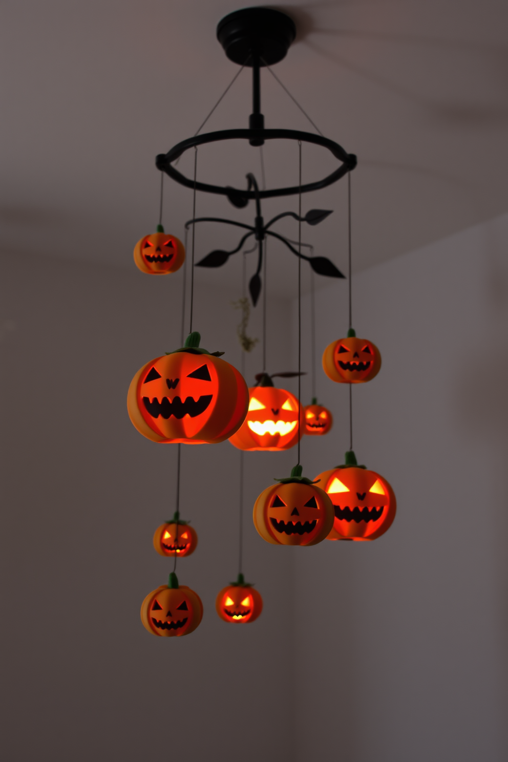 A spooky pumpkin mobile hangs from the ceiling, featuring various sizes of carved pumpkins with playful expressions. Soft, ambient lighting casts eerie shadows, creating a whimsical yet haunting atmosphere perfect for a Halloween nursery.