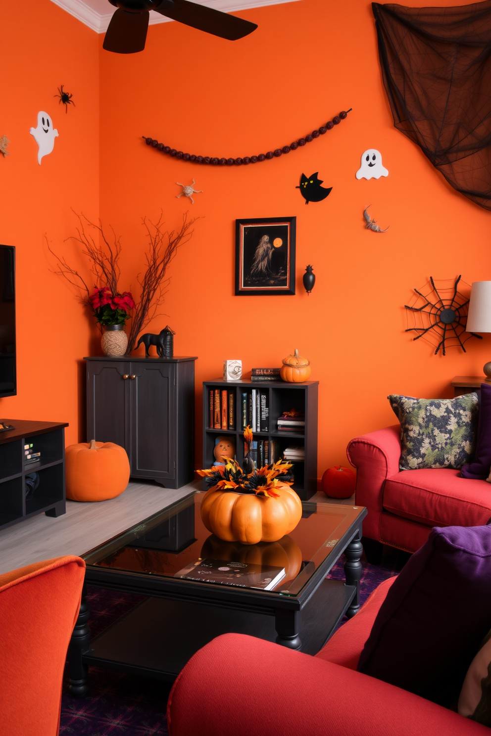 A cozy living room adorned with seasonal Halloween decor. Rich oranges and deep purples fill the space, complemented by black accents like a stylish pumpkin centerpiece on the coffee table. The walls are decorated with playful ghost and spider web motifs. A small bookshelf displays spooky-themed books and a few autumn leaves, adding a festive touch to the limited area.