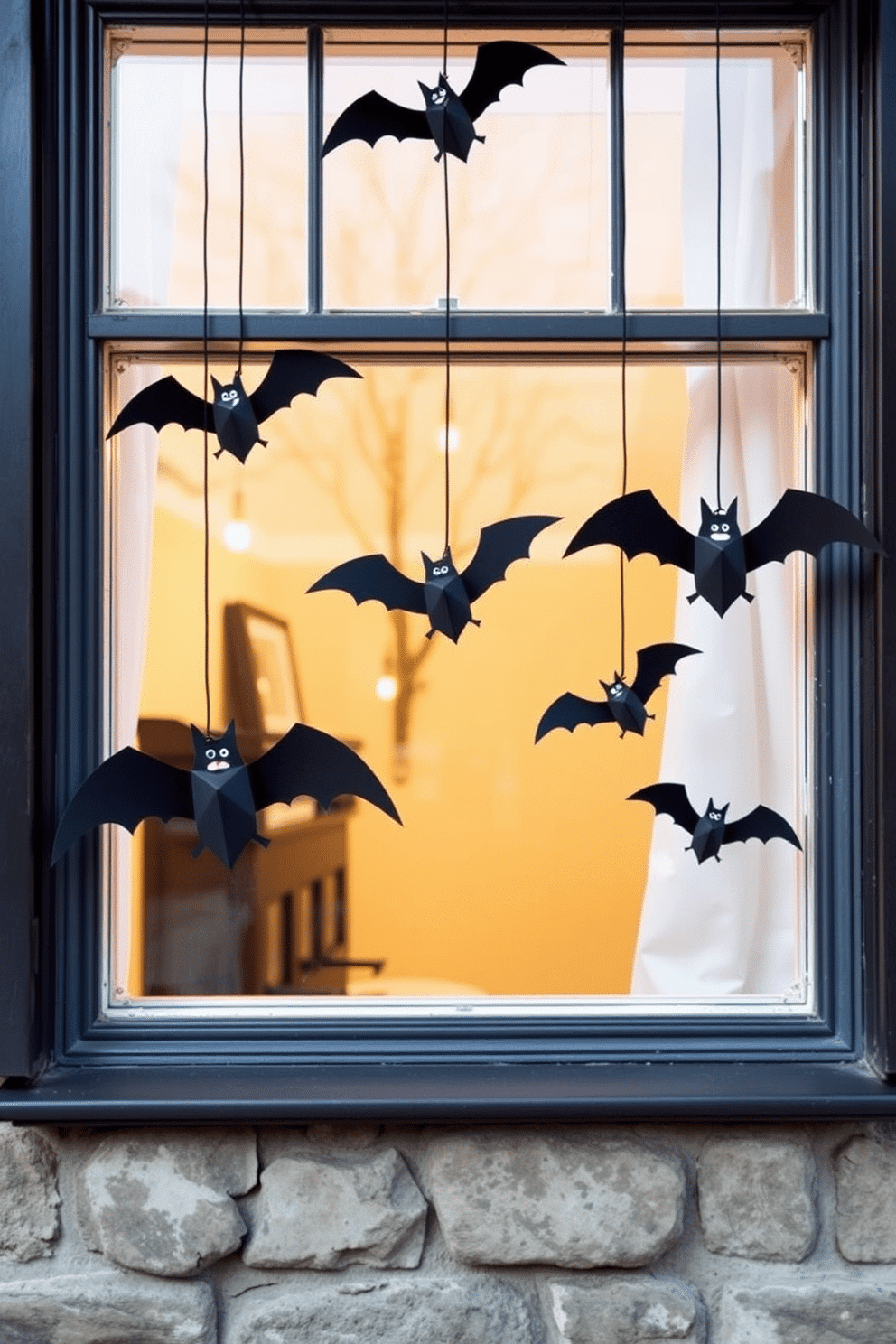 Create a whimsical Halloween window display featuring hanging bats made from black paper. The bats should vary in size and be suspended at different heights to create an enchanting effect.