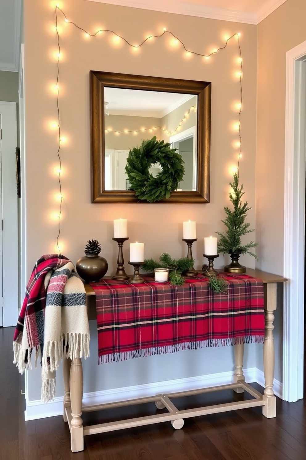 A stylish hallway features a console table adorned with a plaid runner that adds a festive touch. Above the table, a large mirror reflects the warm glow of string lights draped along the walls. To enhance the holiday spirit, the table is decorated with a collection of pinecones, candles, and small evergreen arrangements. A cozy throw blanket in complementary colors is casually draped over one side of the console, inviting guests to feel at home.