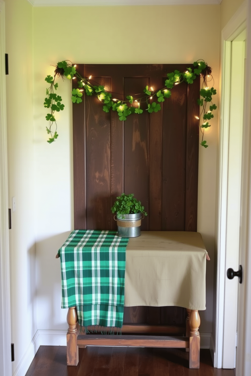 A cozy hallway adorned for St. Patrick's Day features a green plaid tablecloth draped over a rustic wooden console table. Above the table, a charming garland of shamrocks and fairy lights creates a festive atmosphere, while a small potted clover plant adds a touch of greenery.