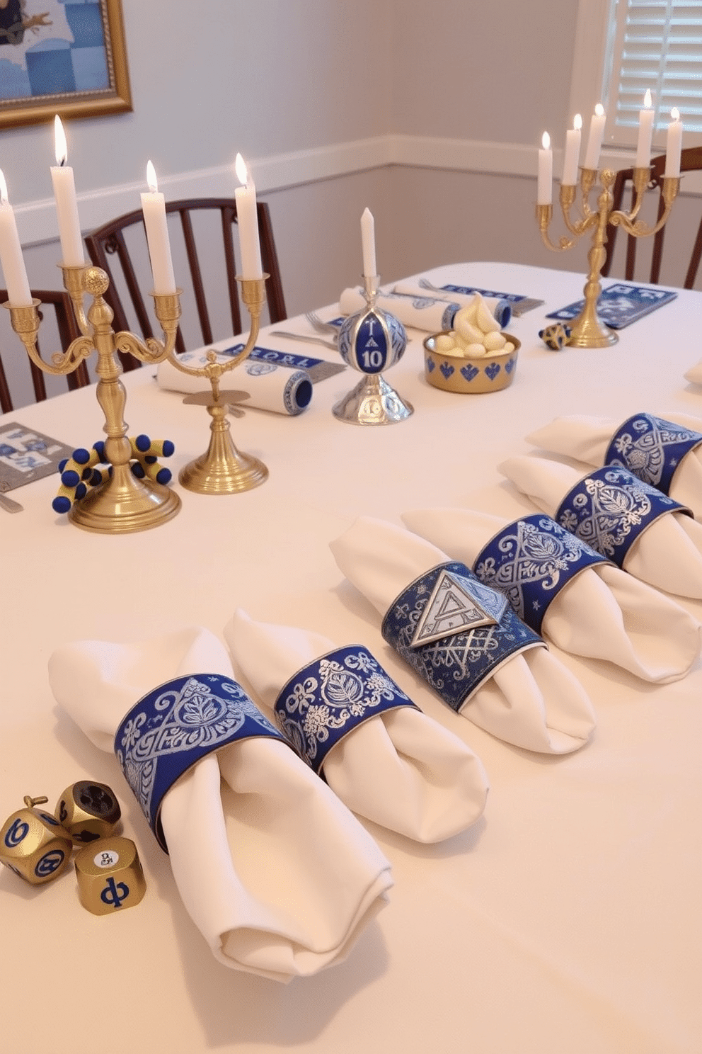 Colorful napkin rings adorned with festive designs create a cheerful table setting for Hanukkah celebrations. Each napkin ring features intricate patterns in shades of blue, silver, and white, reflecting the traditional colors of the holiday. The dining table is elegantly set with a crisp white tablecloth, allowing the vibrant napkin rings to stand out. Surrounding the table are decorative menorahs and clusters of dreidels, enhancing the festive atmosphere.