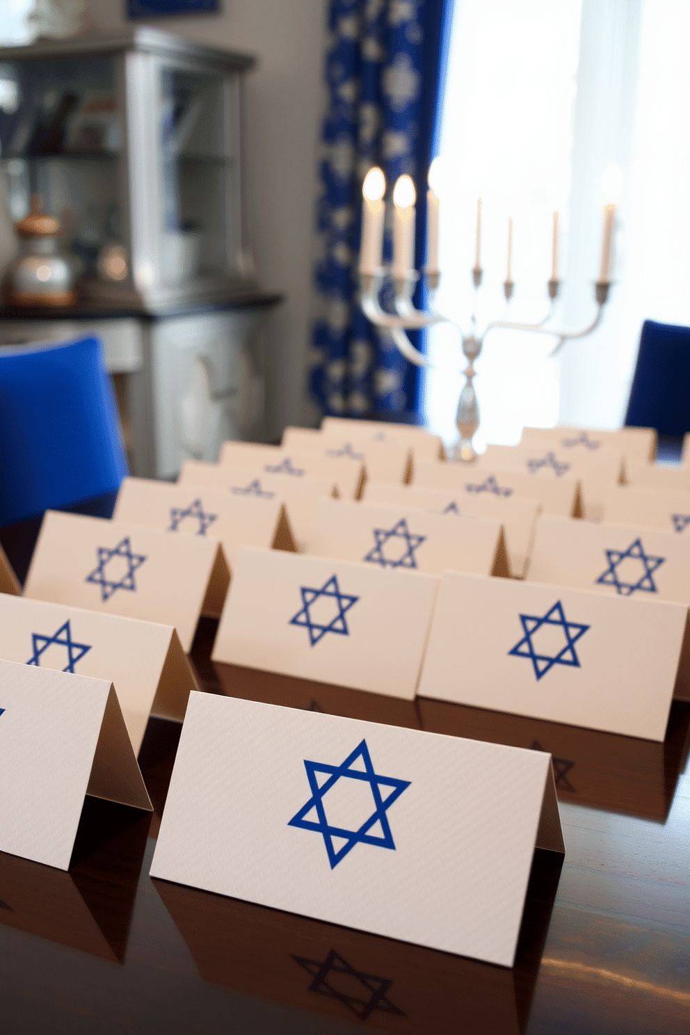 Personalized place cards for each guest. Each card features elegant calligraphy on a textured cream paper, adorned with a small gold star of David. Hanukkah decorating ideas. The space is filled with vibrant blue and silver accents, including a beautifully lit menorah as the centerpiece on the dining table.