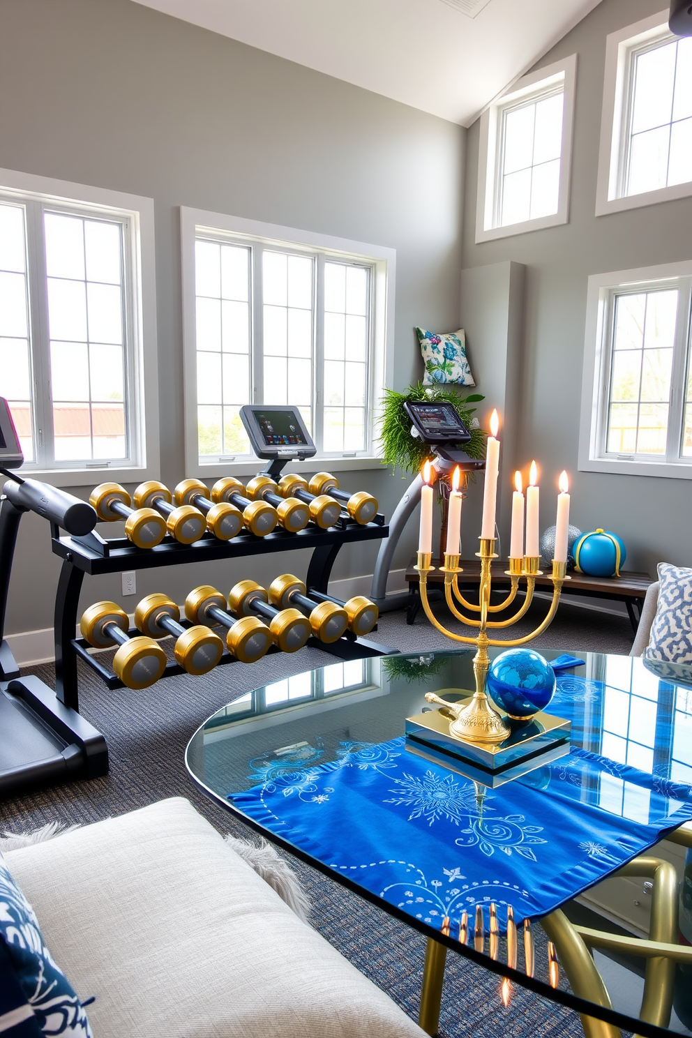 A modern home gym featuring gold and silver dumbbells neatly arranged on a sleek black rack. The walls are painted in a soft gray, and large windows allow natural light to flood the space, creating an inviting atmosphere. Elegant Hanukkah decorations adorn the room, with a beautifully lit menorah on a glass table. Festive blue and silver accents are incorporated through decorative pillows and a vibrant table runner, enhancing the celebratory mood.