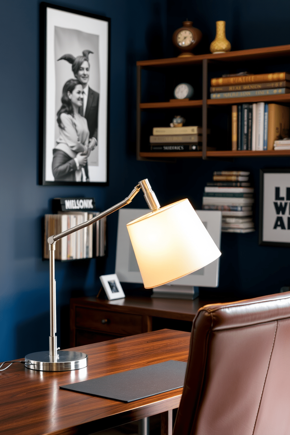 A stylish desk lamp designed for task lighting features a sleek metal base and an adjustable arm, allowing for optimal positioning. The lampshade is a warm white, providing a soft glow that enhances focus without straining the eyes. In a modern home office for men, the space is defined by a rich wooden desk paired with a comfortable leather chair. The walls are painted in a deep navy blue, accented by industrial-style shelving that displays books and decor items.