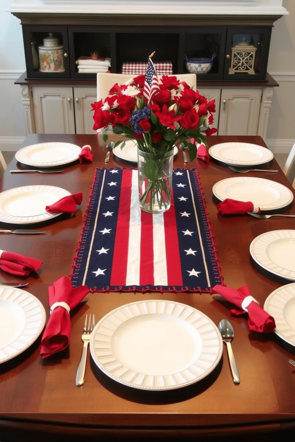 A festive dining table adorned with a stars and stripes table runner as the centerpiece. Surrounding the table are elegant white plates and vibrant red napkins, creating a patriotic atmosphere for Independence Day celebrations.