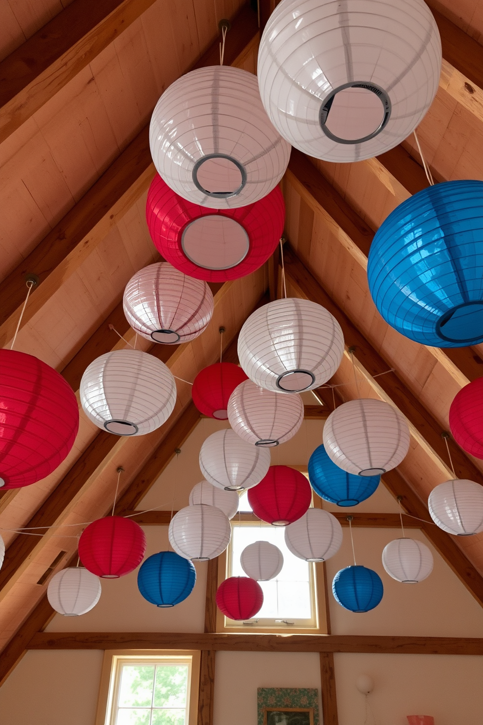 A cozy attic space adorned with hanging paper lanterns in red, white, and blue. The lanterns create a festive atmosphere, complementing the rustic wooden beams and soft natural light filtering through the windows.