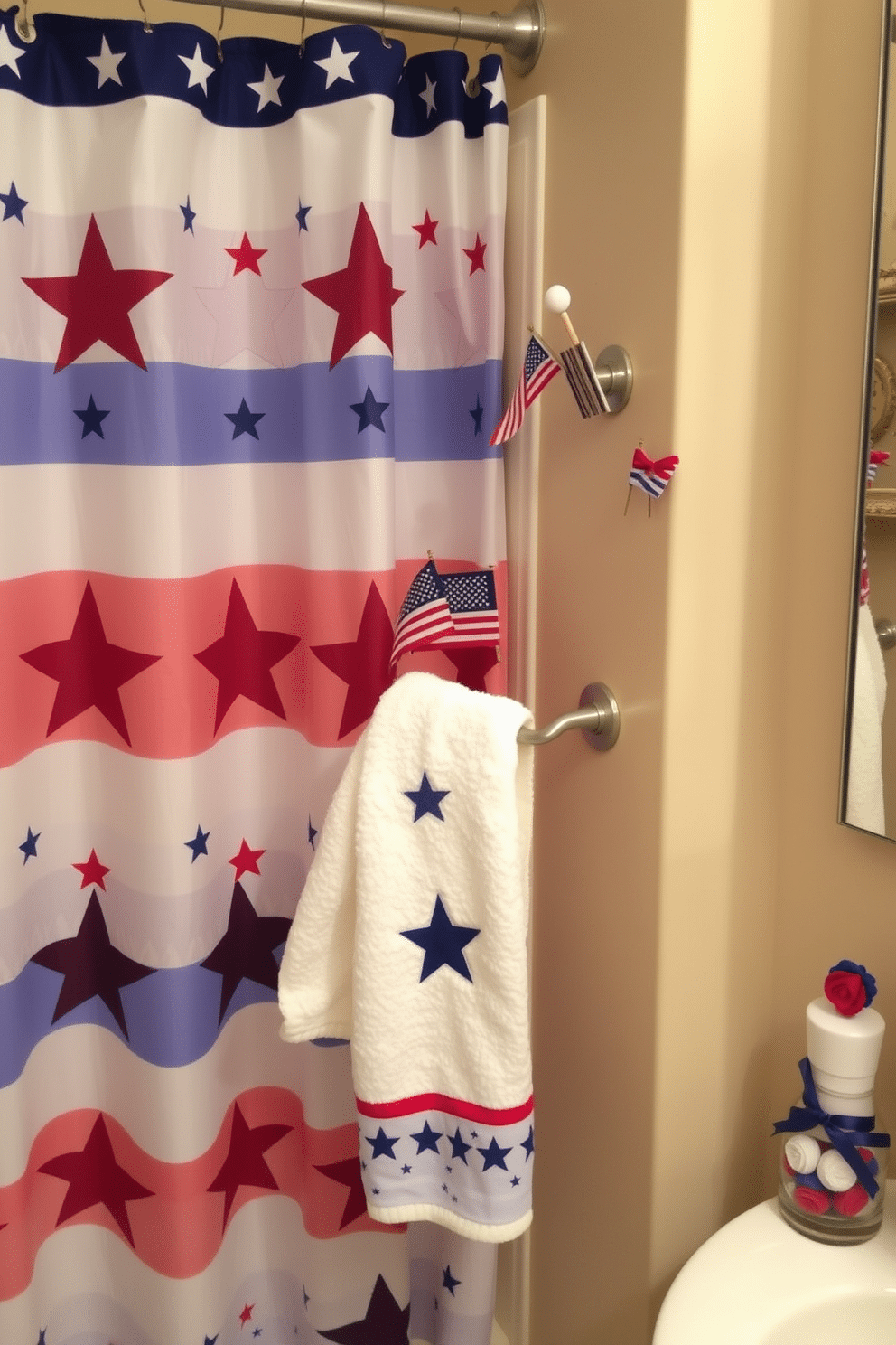 A festive bathroom scene celebrating Independence Day. The shower curtain is adorned with vibrant red white and blue stars and stripes, while the hooks feature charming miniature flags. The countertop is decorated with patriotic-themed accessories including a small vase of red white and blue flowers. A plush towel in a star pattern hangs neatly on the rack, enhancing the holiday spirit.