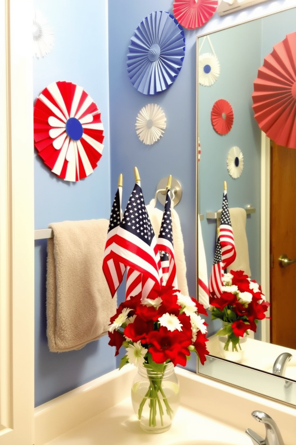 A festive bathroom setting celebrating Independence Day. Mini flags in various sizes are placed on the countertop, adding a touch of patriotic spirit. The walls are adorned with red, white, and blue decorations, creating a vibrant atmosphere. A small bouquet of red and white flowers sits beside the flags, enhancing the celebratory theme.