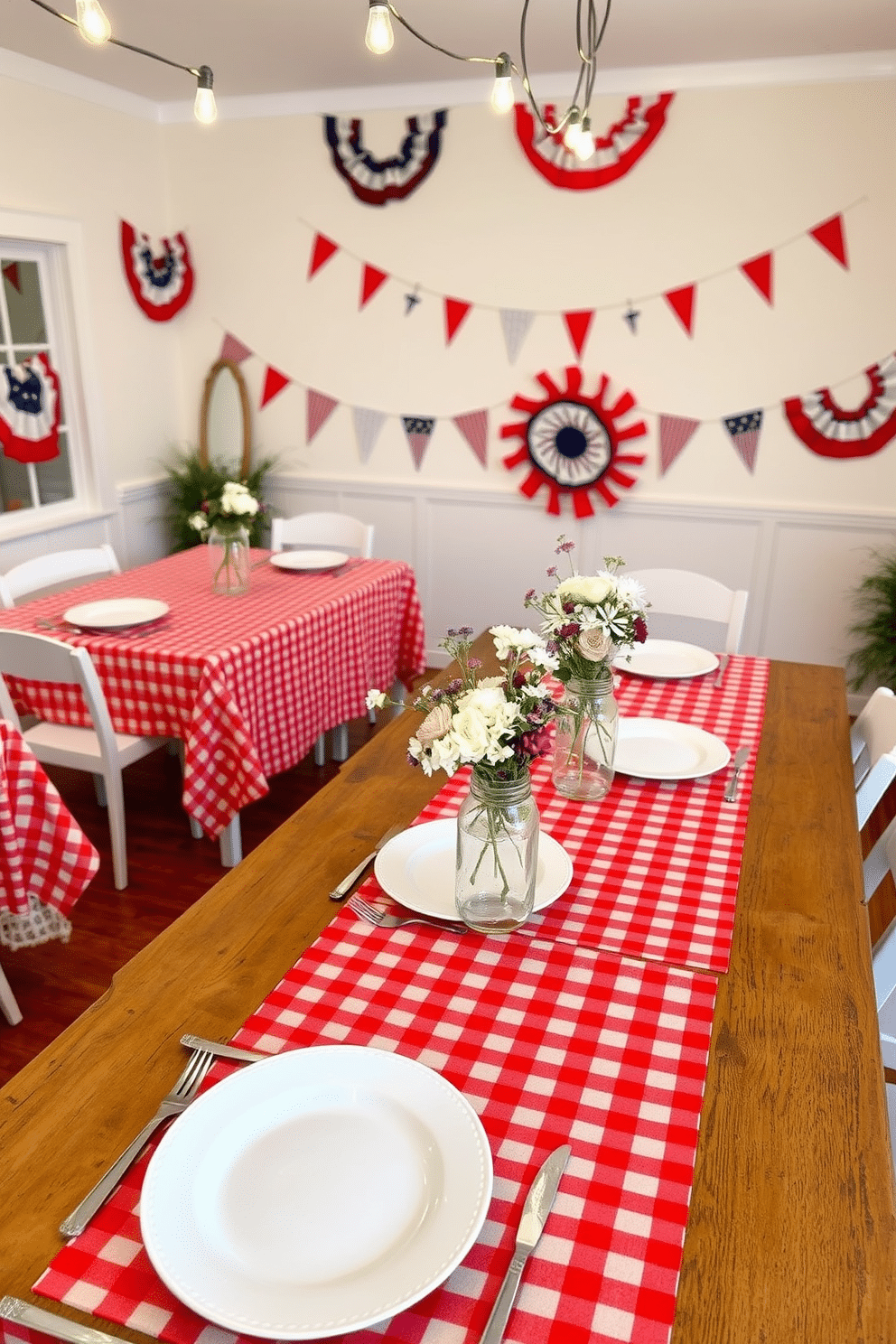 A charming dining room setting featuring red gingham tablecloths draped over a rustic wooden table. The table is adorned with white plates, vintage silverware, and mason jar centerpieces filled with fresh wildflowers. In the background, festive Independence Day decorations hang, including red, white, and blue bunting along the walls. The soft glow of string lights overhead creates a warm and inviting atmosphere for a celebratory gathering.