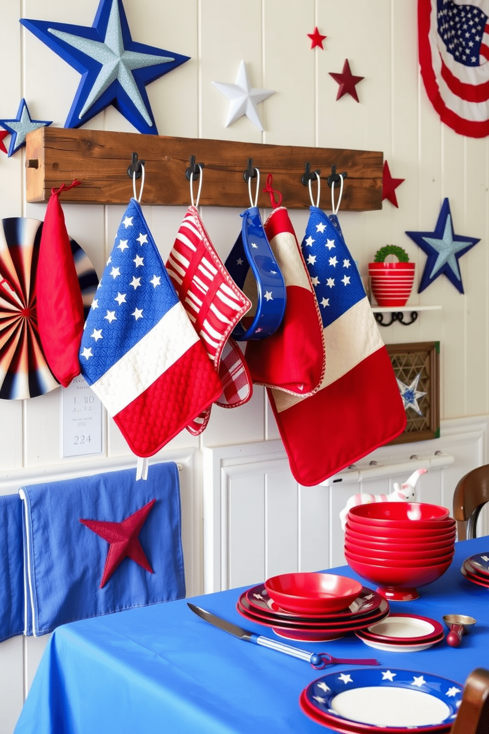 A patriotic themed kitchen setting featuring vibrant red white and blue pot holders hanging from a rustic wooden rack. The walls are adorned with stars and stripes decor while a festive table is set with a blue tablecloth and red white and blue dishes.