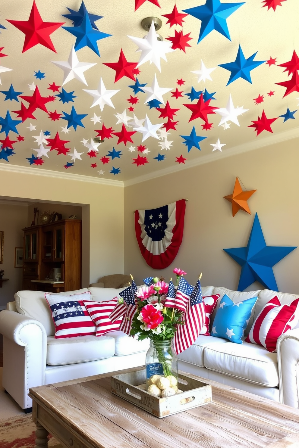 A festive living room setting for Independence Day. The ceiling is adorned with colorful paper stars in red, white, and blue, creating a cheerful atmosphere. A cozy seating area features a white sofa with patriotic throw pillows. A rustic coffee table is decorated with a centerpiece of flowers in a mason jar and small American flags.