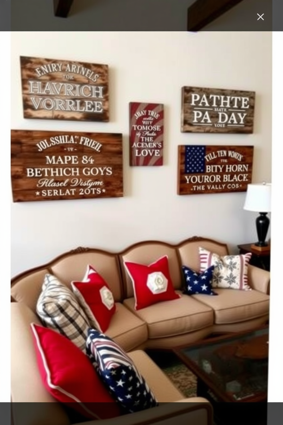 Rustic wooden signs adorned with patriotic quotes hang on the walls, adding a warm and inviting touch to the living room. The decor features a cozy arrangement of vintage furniture, with a large sectional sofa dressed in red, white, and blue throw pillows.