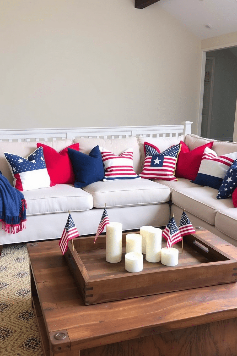 A cozy loft space adorned with patriotic throw pillows in red, white, and blue. The pillows are arranged on a plush sectional sofa, creating a festive and inviting atmosphere for Independence Day celebrations. The walls are painted in a soft neutral tone, allowing the vibrant colors of the pillows to stand out. A rustic wooden coffee table sits in front of the sofa, topped with a decorative tray featuring candles and small American flags.