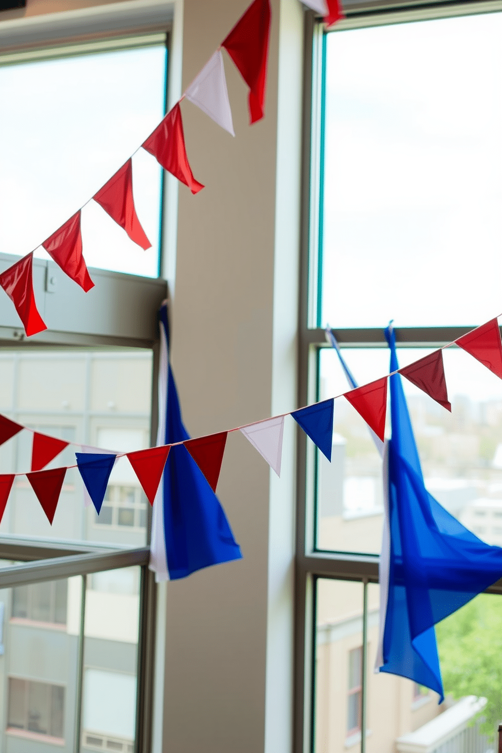 A festive loft decorated for Independence Day features colorful bunting draped across large windows. The vibrant red, white, and blue fabric flutters gently in the breeze, adding a cheerful atmosphere to the space.