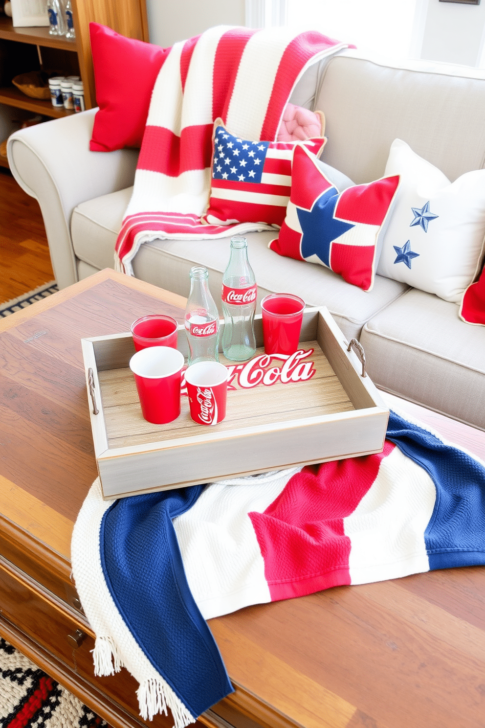 A classic Coca-Cola serving tray display featuring a vintage tray at the center adorned with retro glass bottles and a couple of classic red cups. The tray is set on a rustic wooden coffee table surrounded by a cozy arrangement of plush cushions in vibrant colors. Independence Day small living room decorating ideas with a patriotic theme highlighted by red, white, and blue accents. A stylish flag-themed throw blanket drapes over a comfortable sofa, while decorative stars and stripes pillows add a festive touch to the space.