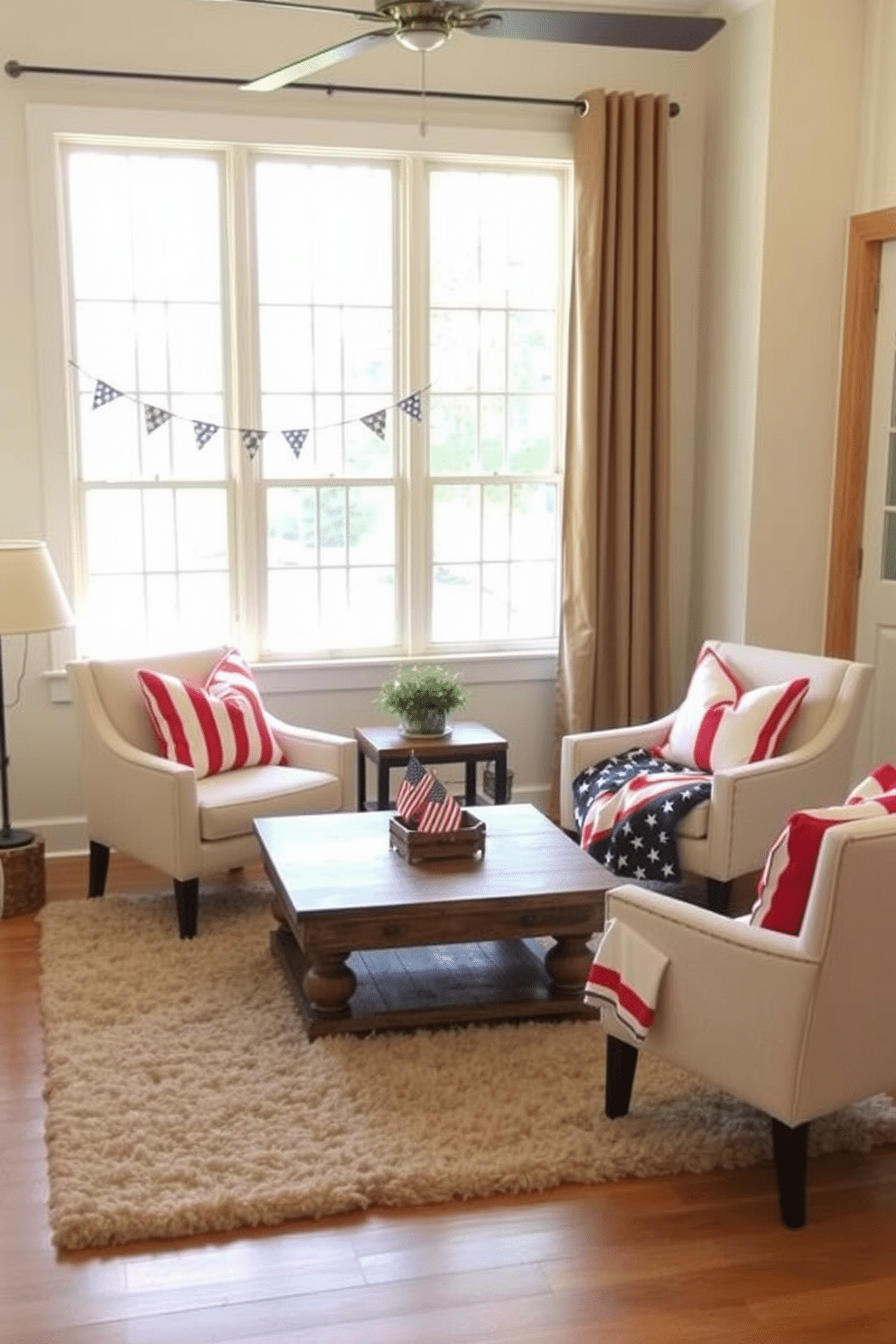 Create a cozy small living room setting featuring accent chairs adorned with red white and blue cushions. The walls are painted a soft cream color and a rustic wooden coffee table sits in the center, surrounded by a plush area rug. Add festive decorations like small flags and a patriotic-themed throw blanket draped over one of the chairs. A large window allows natural light to fill the space, enhancing the cheerful atmosphere.