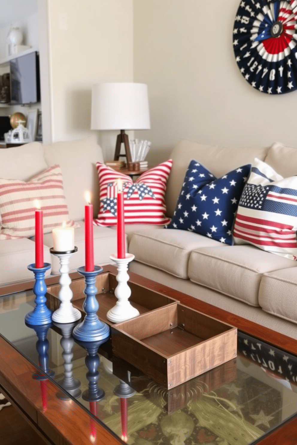 A cozy small living room decorated for Independence Day features candle holders in red, white, and blue placed strategically on a coffee table. Soft throw pillows with stars and stripes patterns add a festive touch to the neutral-colored sofa, creating a warm and inviting atmosphere.