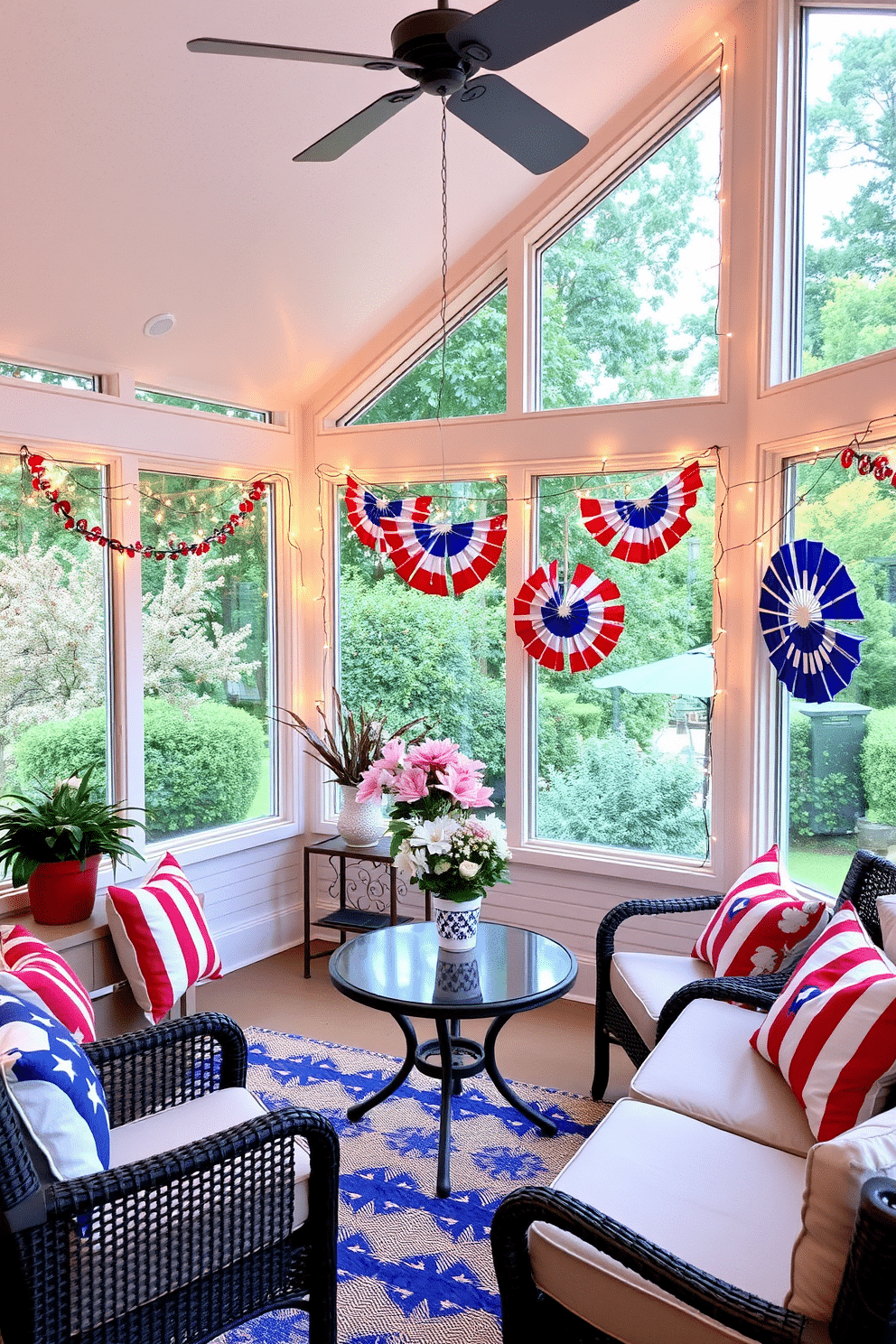 A sunroom decorated for Independence Day features patriotic-themed string lights draped around the windows creating a festive atmosphere. The walls are adorned with red white and blue accents and comfortable seating invites relaxation while celebrating the holiday.