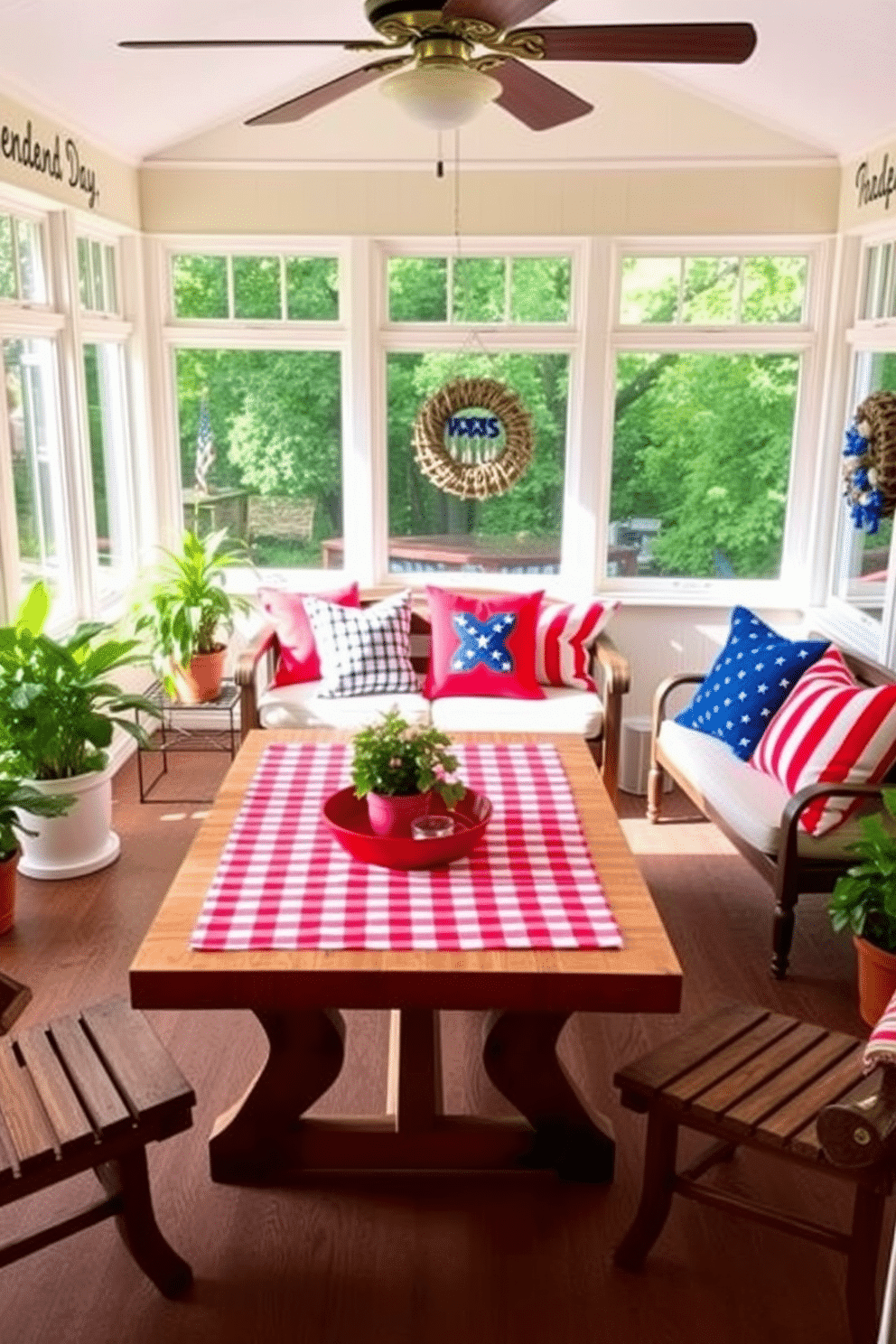 A cheerful sunroom decorated for Independence Day features a red and white checkered picnic blanket spread across a wooden table. Vibrant red and blue throw pillows are arranged on a cozy seating area, with potted plants adding a touch of greenery.