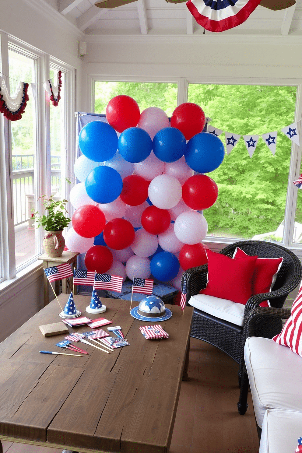 A festive Fourth of July themed photo booth corner featuring a backdrop of red white and blue balloons arranged in a star shape. In the foreground a rustic wooden table displays patriotic props such as mini flags and themed hats for guests to use. The sunroom is adorned with cheerful decorations including bunting made of stars and stripes. Comfortable seating with red and white cushions invites guests to relax and enjoy the Independence Day celebrations.