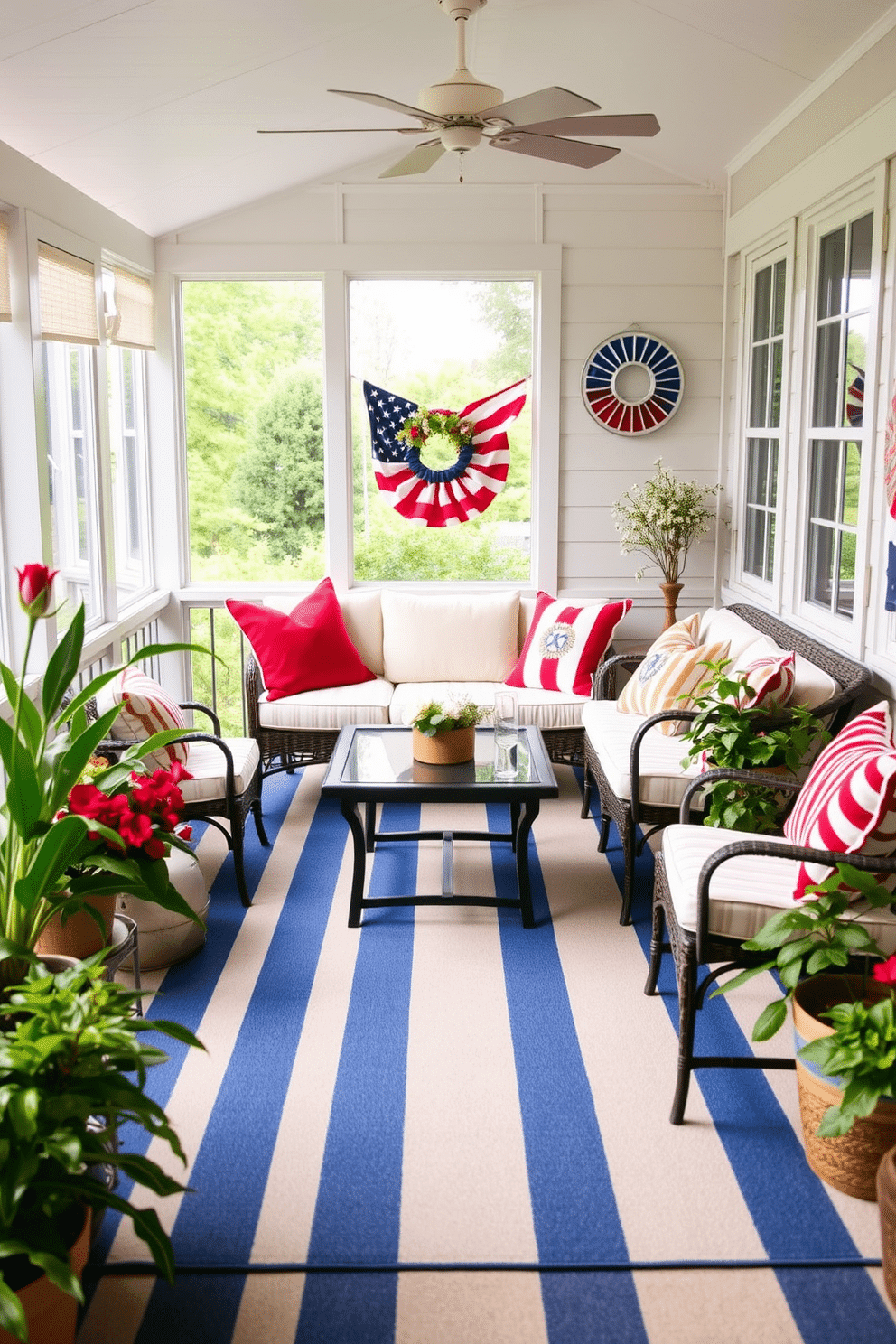 A cozy sunroom adorned with a blue and white striped outdoor rug that brings a fresh and festive vibe. The space features comfortable seating with plush cushions in red and white, complemented by patriotic decor celebrating Independence Day.