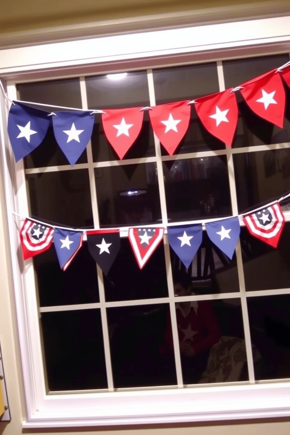 Mini banners across window sills create a festive atmosphere for Independence Day celebrations. The banners feature red white and blue colors with stars and stripes adding a patriotic touch to any room.