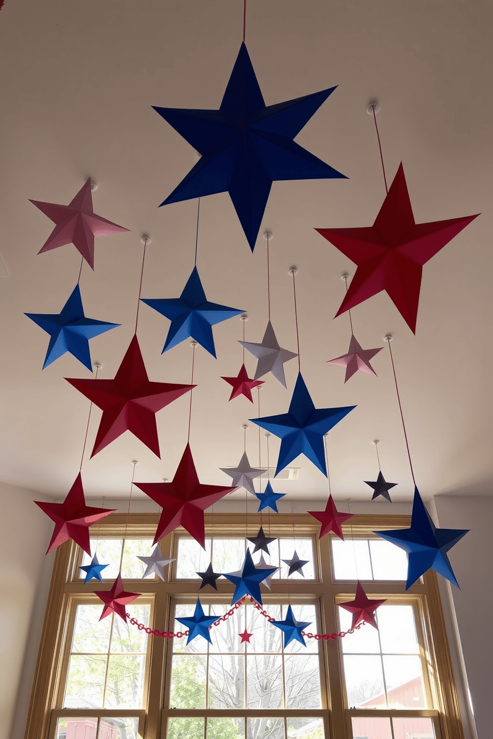 A festive display of hanging stars adorns the ceiling above the windows, creating a celebratory atmosphere for Independence Day. The stars are crafted in red, white, and blue, adding a vibrant touch to the room while allowing natural light to filter through.