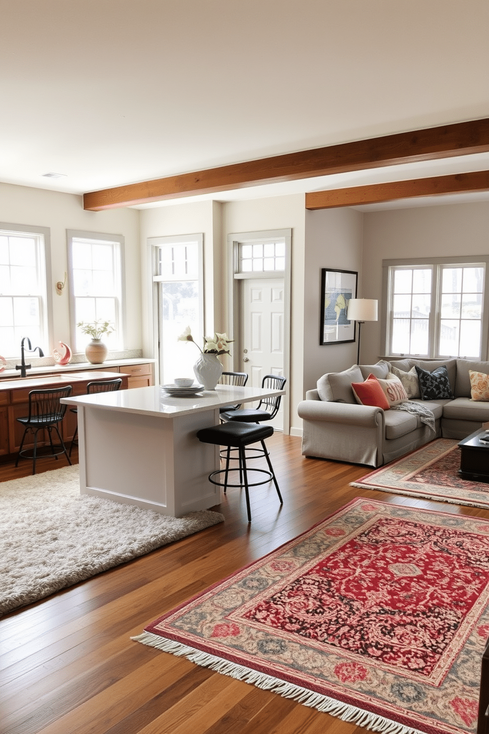 A cozy kitchen-family room combo features a large, plush area rug that anchors the seating area, creating a warm and inviting atmosphere. The kitchen island, topped with a beautiful quartz countertop, is complemented by stylish bar stools that invite casual dining and conversation. In the family room, a second area rug delineates the space around a comfortable sectional sofa, adorned with colorful throw pillows. Large windows allow natural light to flood the room, highlighting the harmonious blend of modern and rustic decor elements throughout the space.