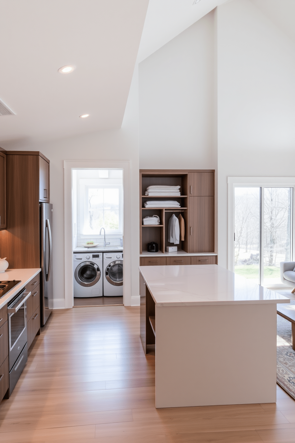 Open layout for seamless flow. The kitchen features a large island with bar seating, complemented by sleek cabinetry and stainless steel appliances. Adjacent to the kitchen, the laundry room is cleverly integrated with built-in shelving and a countertop for folding clothes. Natural light floods the space through a window, creating an inviting and functional area.