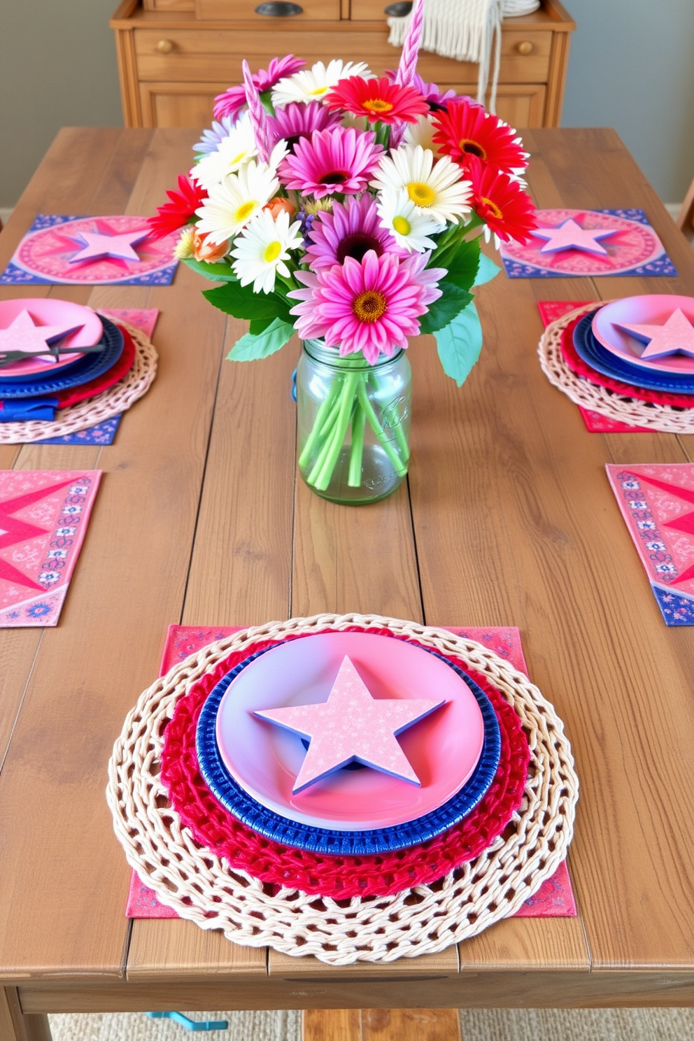 Colorful placemats with star motifs adorn a rustic wooden dining table, creating a festive atmosphere for Labor Day celebrations. The vibrant colors of the placemats complement a centerpiece of fresh flowers in a mason jar, enhancing the cheerful decor.