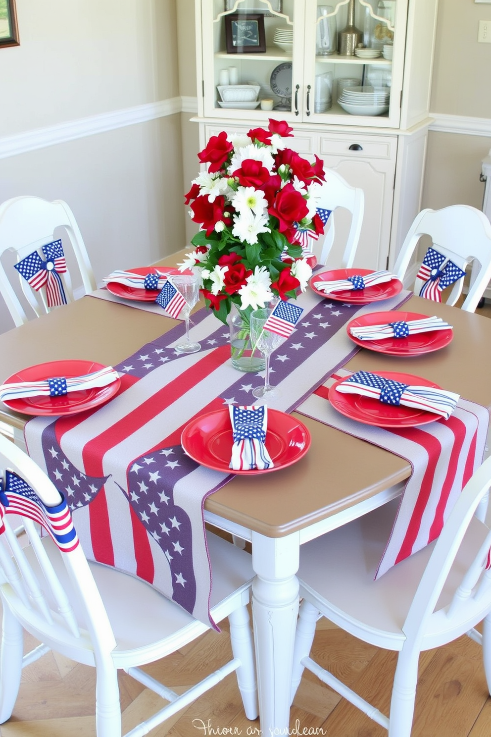 A festive dining table adorned with American flag themed table runners. The table is set with red, white, and blue plates and star-shaped napkin holders for a patriotic touch. Surrounding the table are mismatched chairs, each draped with a small flag banner. Centerpiece arrangements of fresh flowers in red and white hues complete the Labor Day celebration decor.